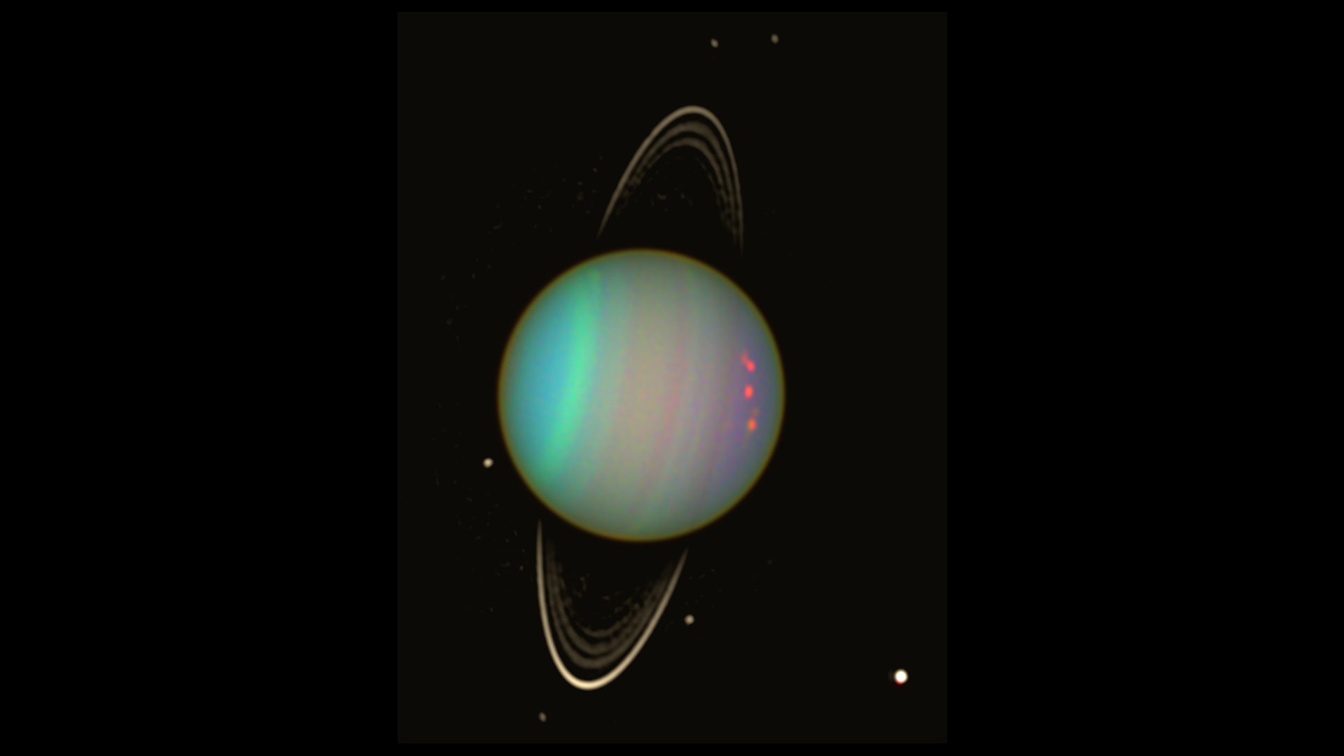 Uranus is seen in this false-color view from NASA's Hubble Space Telescope from August 2003. The brightness of the planet's faint rings and dark moons has been enhanced for visibility. Image credit: NASA/Erich Karkoschka (Univ. Arizona)